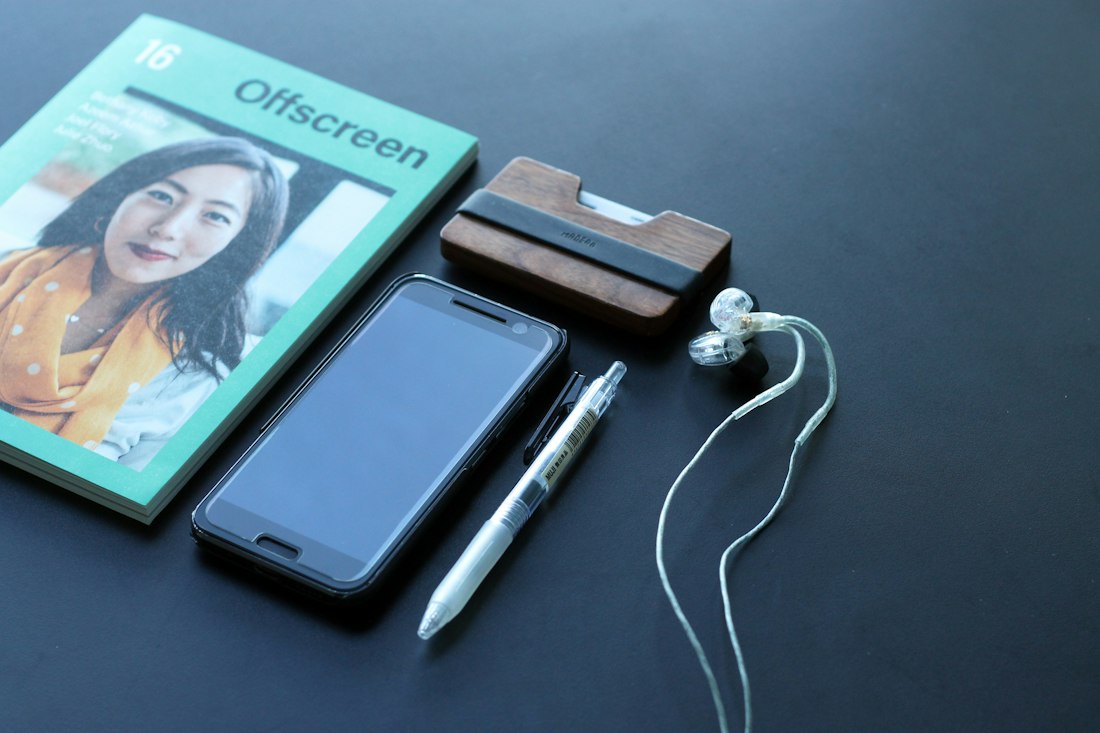 Smartphone and earbuds on a desk