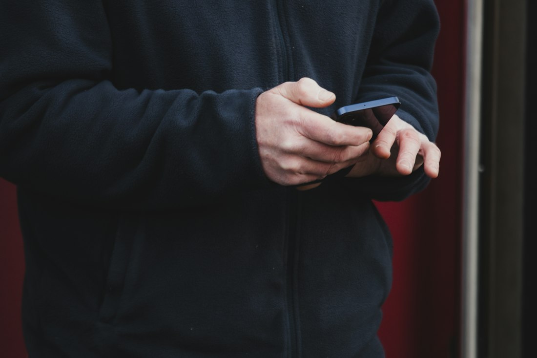 Person holding and using a smartphone